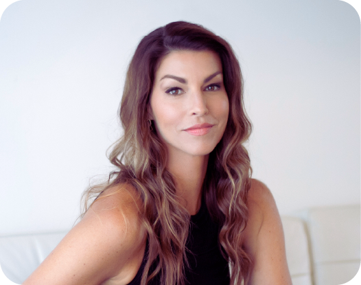 woman posed on chair with top of couch behind her