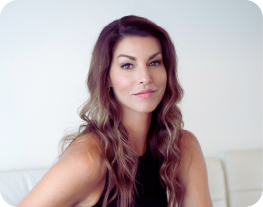 woman posed on chair with top of couch behind her